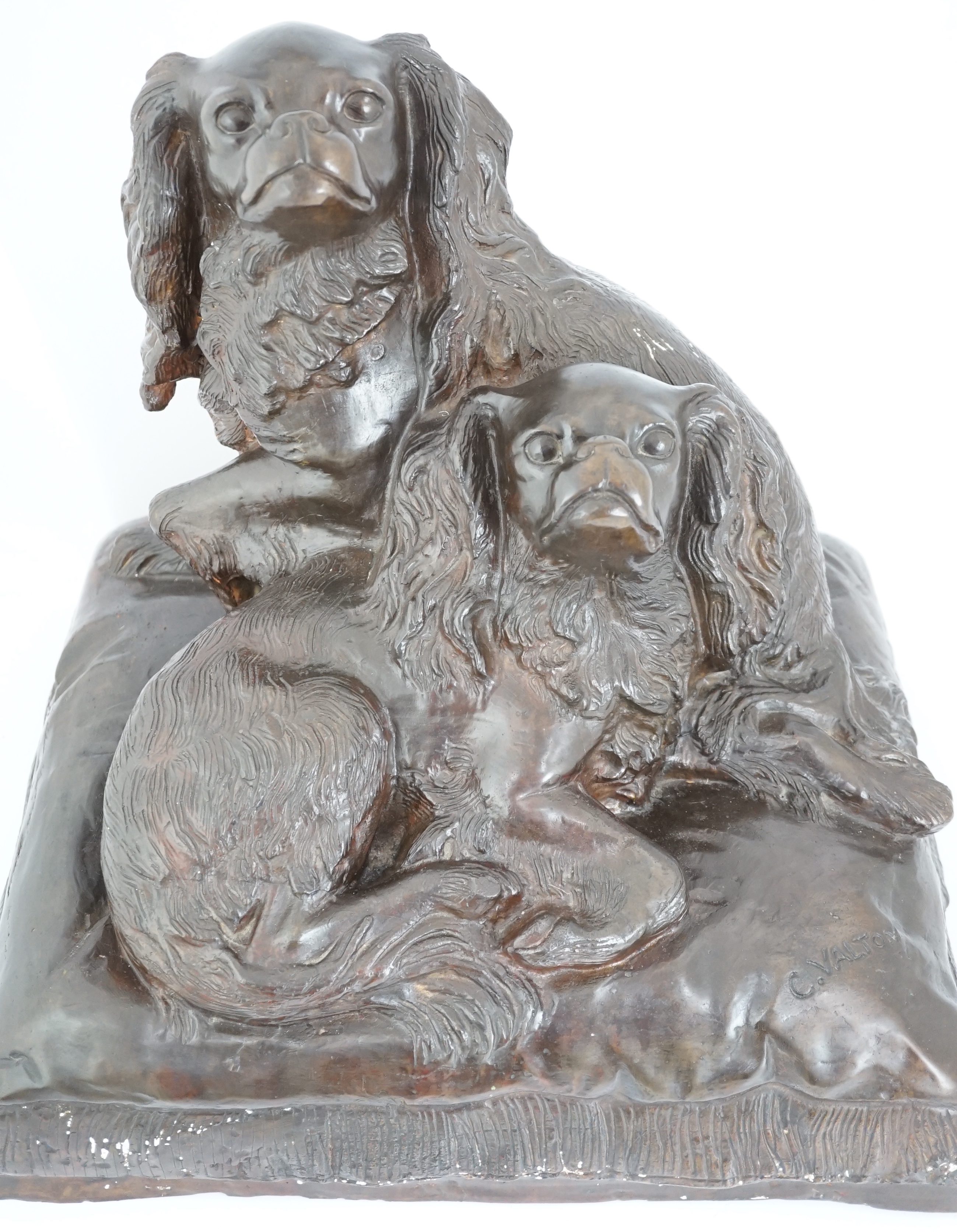 After Charles Valton (French, 1851-1819), a bronze group of two King Charles spaniels seated upon a cushion, 46cm wide, 42cm high